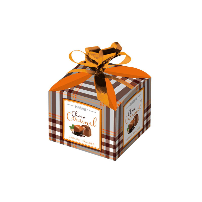 Caramel pralines in a small gift box with a bow