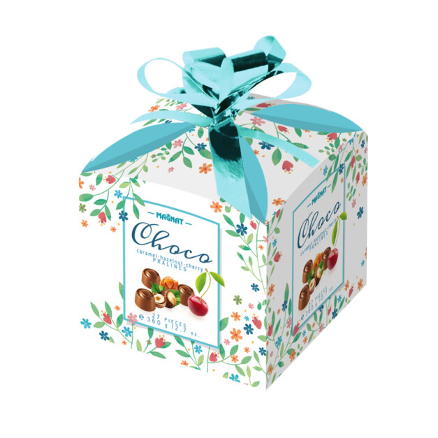 Chocolate pralines in a big box with a bow