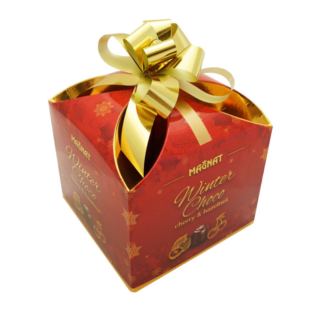 Chocolate pralines in a gift box with a bow